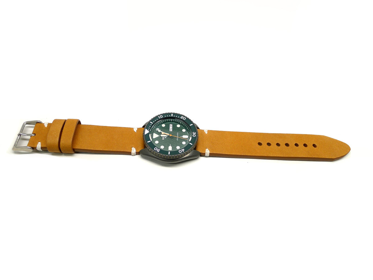 Audeau watch strap in ochre with white accent stitches, shown fitted to a watch.