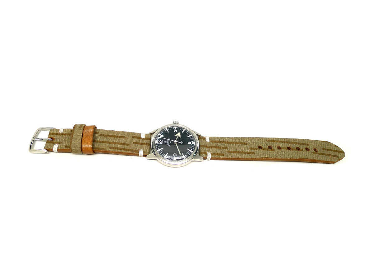 Barek watch strap in tan with brown stripes and an orange keeper, shown fitted to a watch.