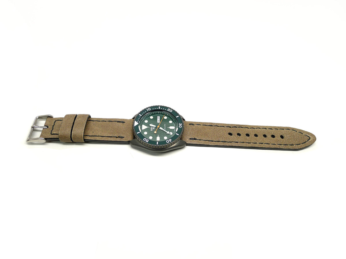 Burdu watch strap in tan with dark edge stitching, shown fitted to a watch.