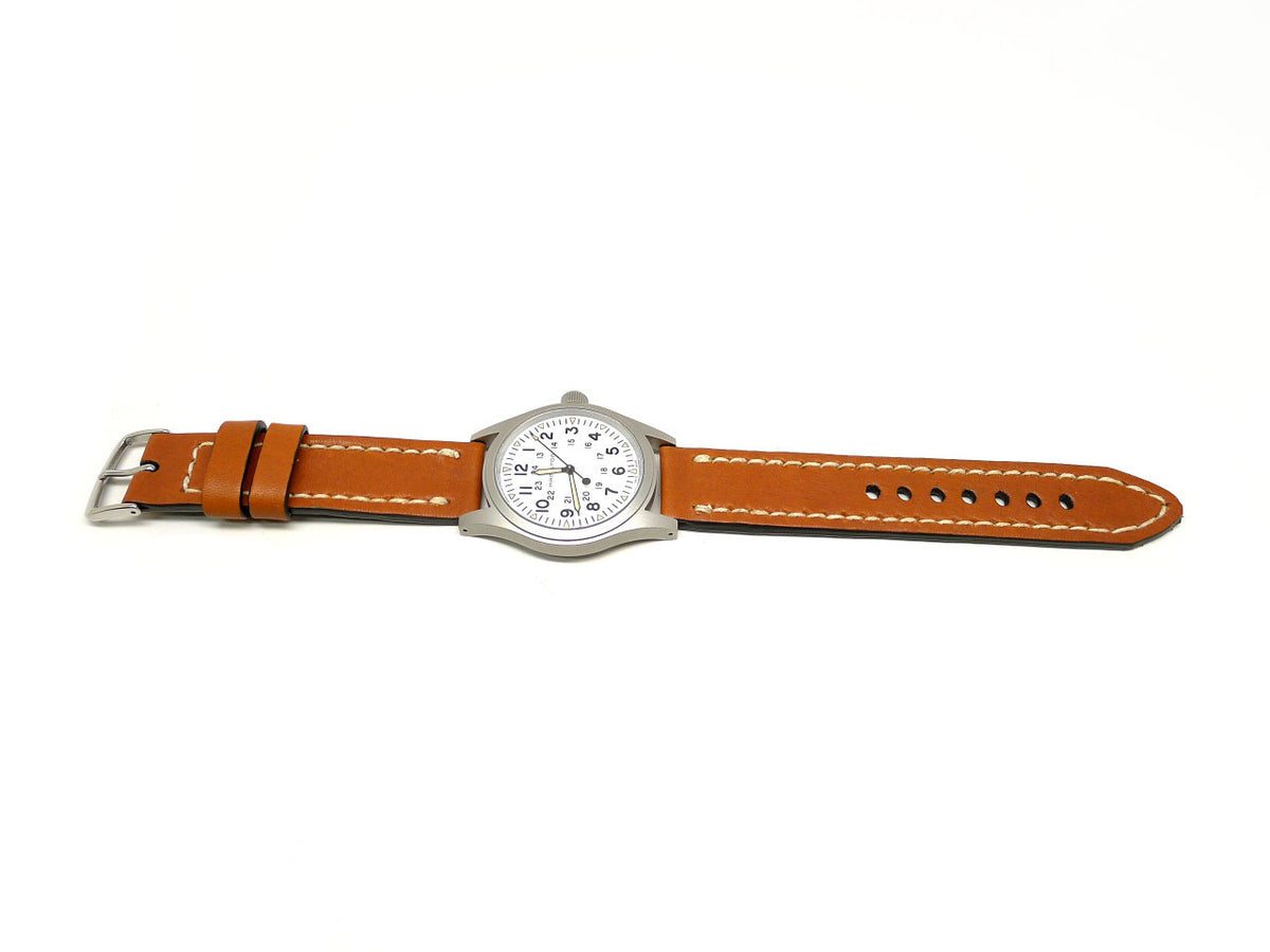 Chips watch strap in orange brown with cream edge stitching, shown fitted to a watch.