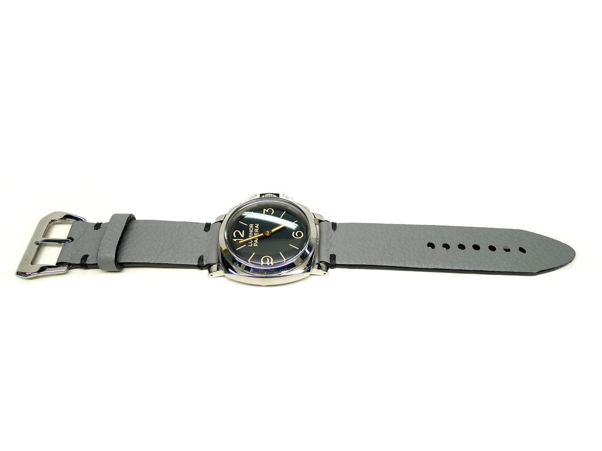 Griseo watch strap in gray with dark accent stitches, shown fitted to a watch.