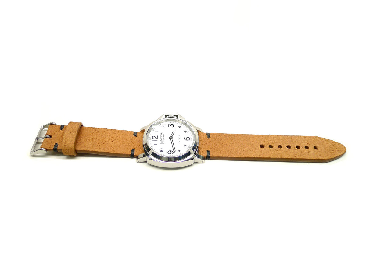 Peelah watch strap in tan with a textured surface and dark accent stitches, shown fitted to a watch.