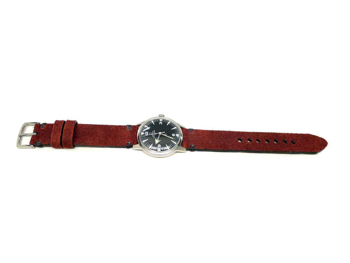 Sauthern watch strap in dark red with a textured surface and dark accent stitches, shown fitted to a watch.