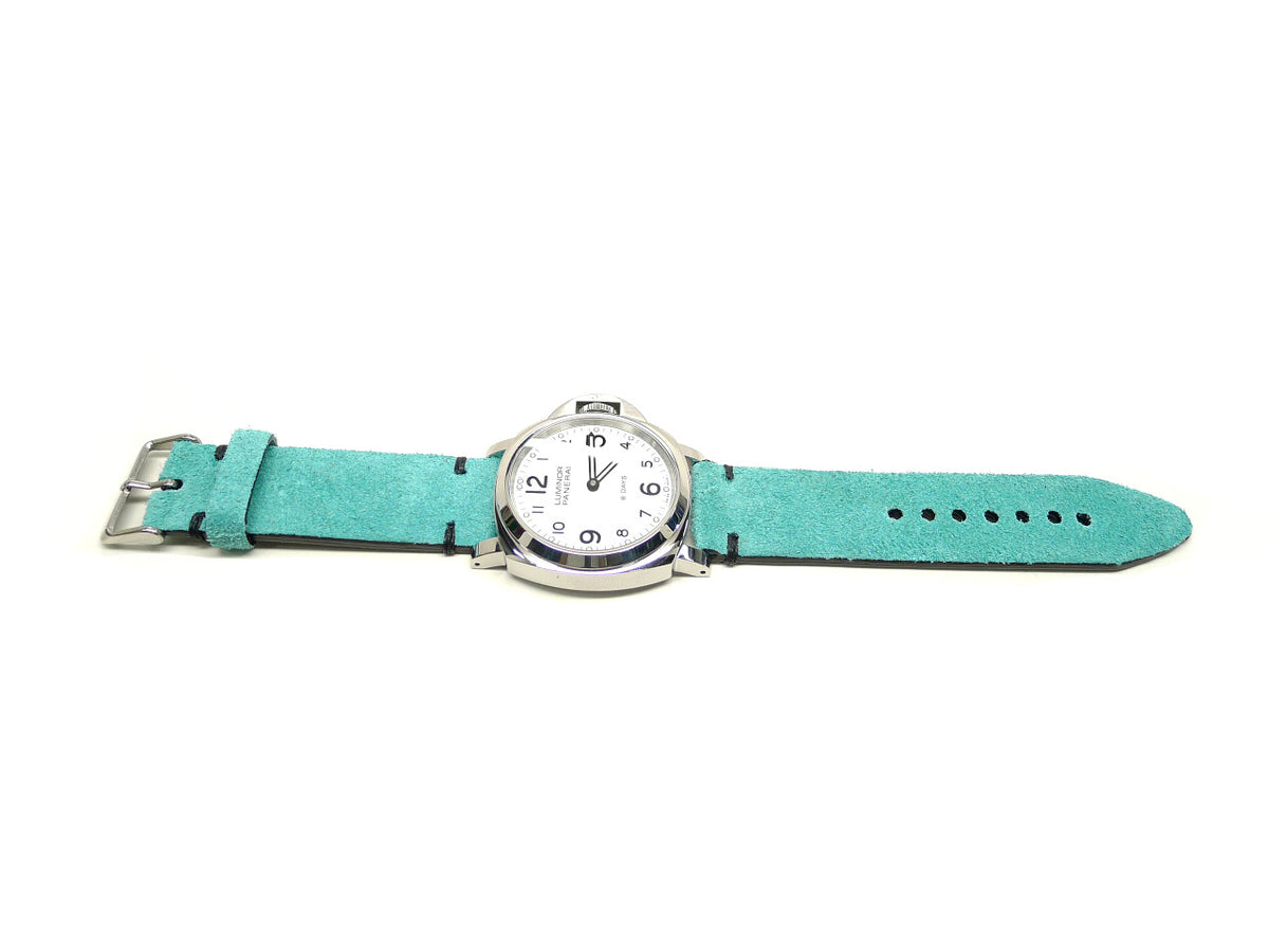 Shlockey watch strap in turquoise with a textured surface and dark accent stitches, shown fitted to a watch.