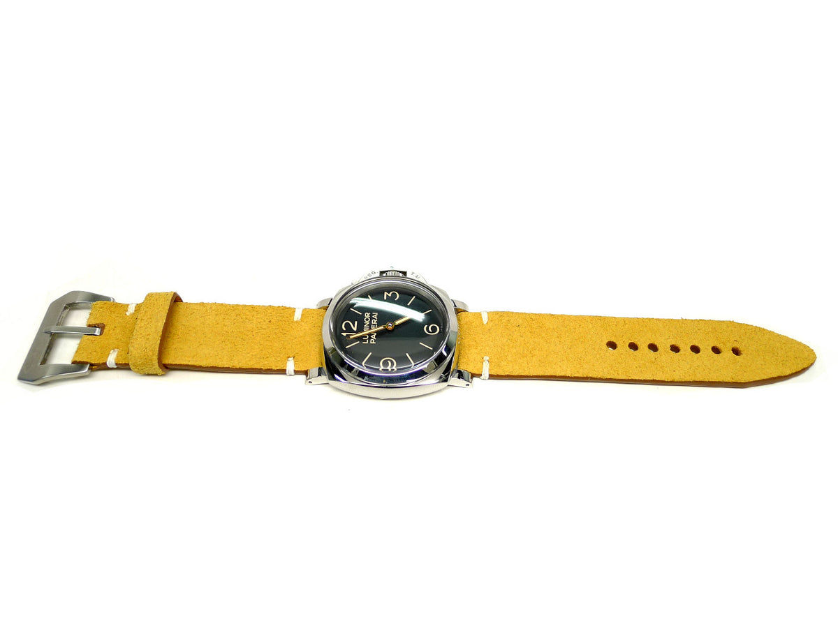 Solis watch strap in yellow with a textured surface and white accent stitches, shown fitted to a watch.