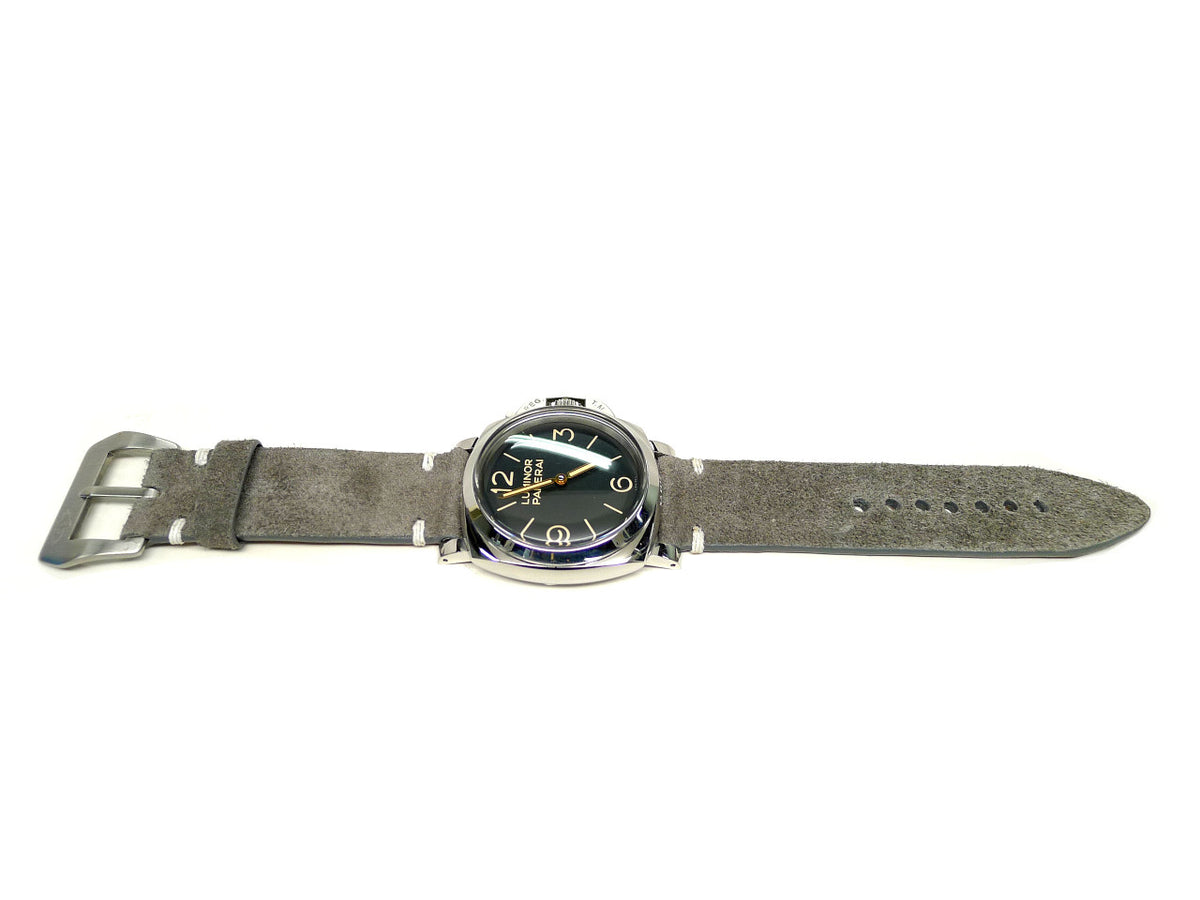Wax watch strap in gray brown with a textured surface and white accent stitches, shown fitted to a watch.