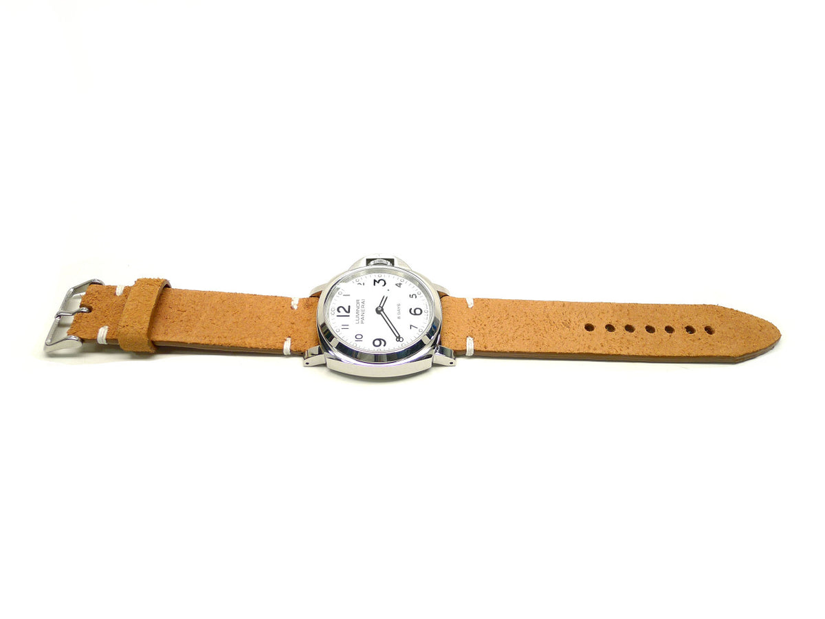 Zoomzi watch strap in tan with a textured surface and cream accent stitches, shown fitted to a watch.