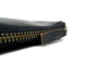 Pull Detail Of A Handmade Zip Wallet Made From Horween Black Chromexcel Leather with a Black Zipper DaLuca Straps.