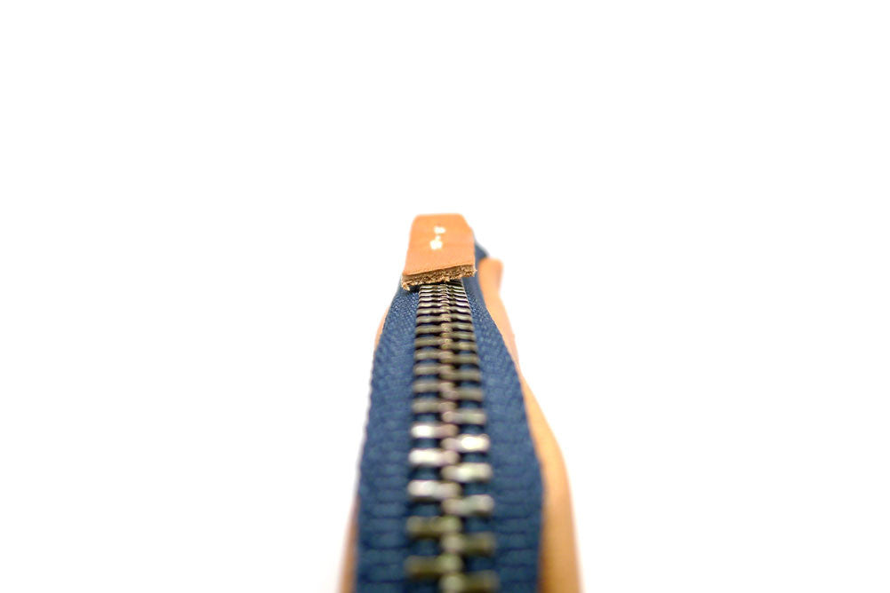 Zip Pull Detail Of Our Handmade Zip Wallet Made From Horween Natural Essex Leather with a Blue Zipper DaLuca Straps.