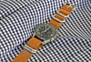 A Light Brown Ballistic Nylon Military Watch Strap With A Matte Silver Buckle By DaLuca Straps.