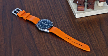 orange rubber fkm watch band on an omega speedmaster pro watch