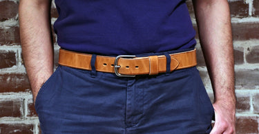 natural leather belt on a waist with blue shirt and pants