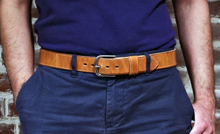 natural leather belt on a waist with blue shirt and pants
