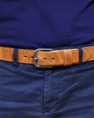 natural leather belt on a waist with blue shirt and pants