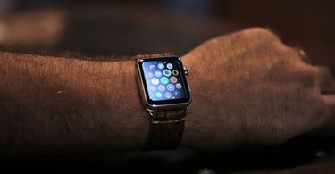 leather watch band on a apple watch on a very hairy arm