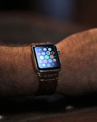leather watch band on a apple watch on a very hairy arm