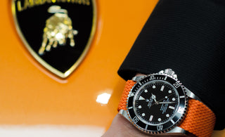 rolex submariner on a orange perlon watch strap and lamborghini