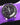 purple omega speeedmaster pro watch in space on a wrist