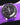 purple omega speeedmaster pro watch in space on a wrist