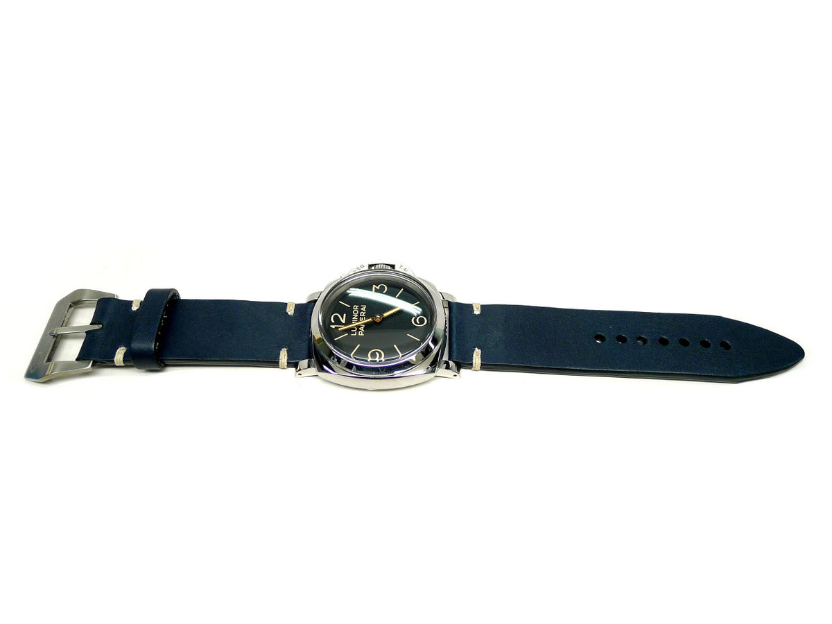 Classe watch strap in dark blue with cream accent stitches, shown fitted to a watch.