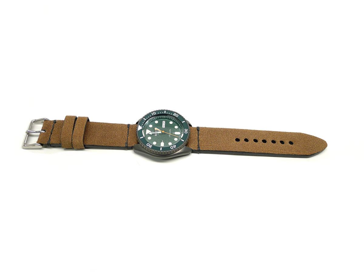 Empruh watch strap in tan with a textured surface and dark stitching, shown fitted to a watch.