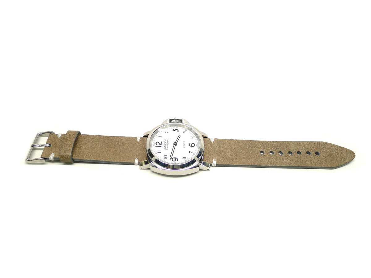 Futaza watch strap in taupe with a textured surface and white accent stitches, shown fitted to a watch.