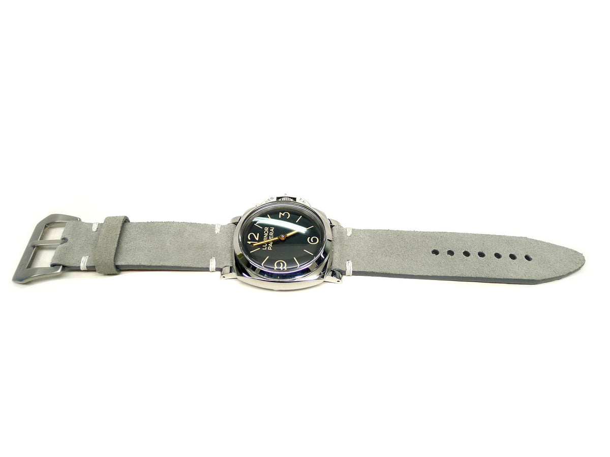 Grit watch strap in light gray with a textured surface and white accent stitches, shown fitted to a watch.