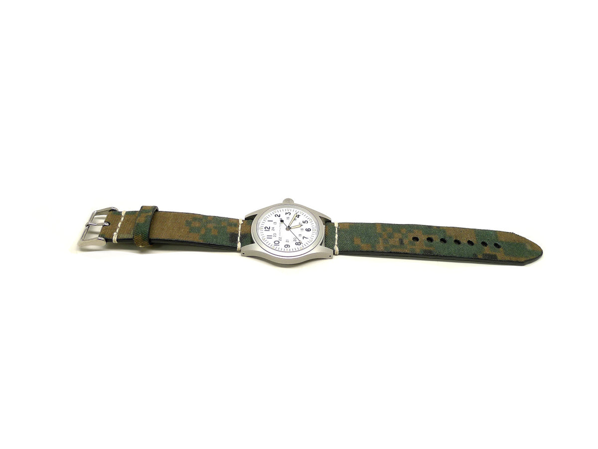 Gunnar watch strap in green and brown with a camouflage pattern and cream accent stitches, shown fitted to a watch.