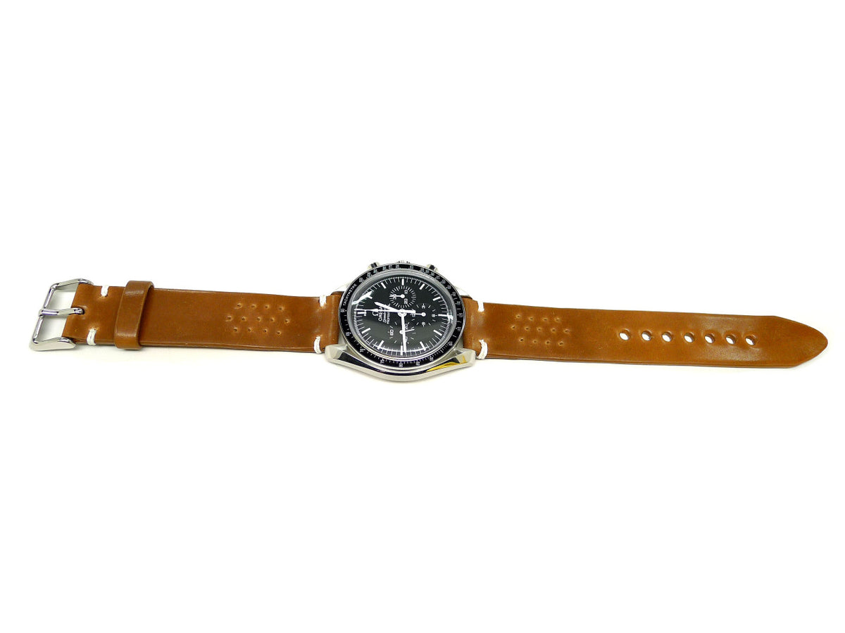 Halfirth watch strap in brown with small perforations and cream accent stitches, shown fitted to a watch.