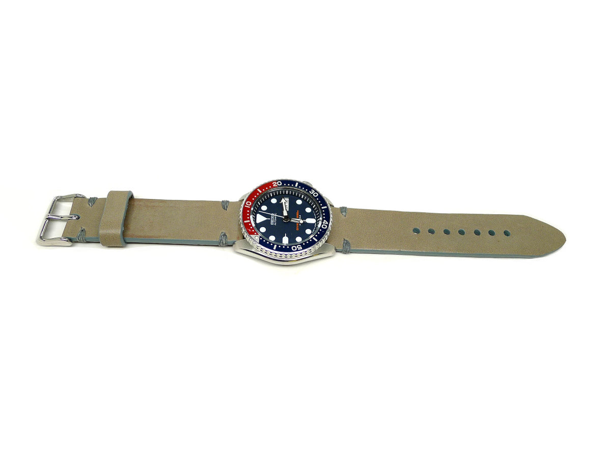Kangchenjunga watch strap in khaki with gray accent stitches, shown fitted to a watch.