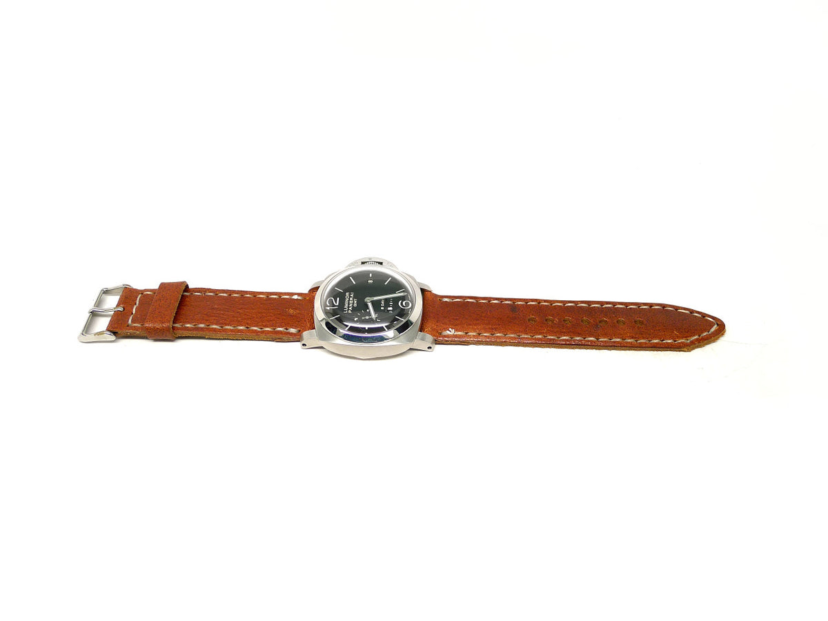 Karpette watch strap in orange brown with cream edge stitching, shown fitted to a watch.