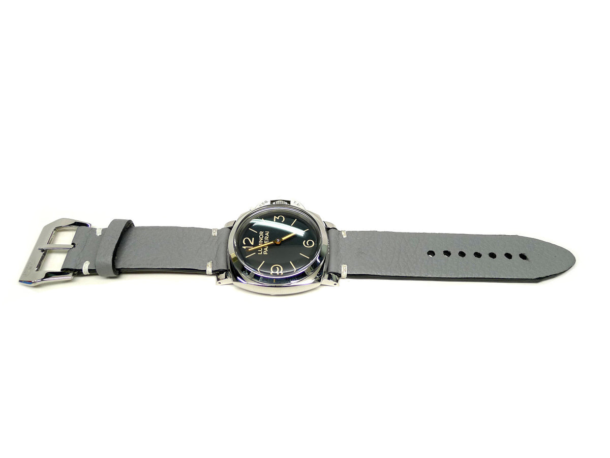 Lapis watch strap in gray with white accent stitches, shown fitted to a watch.