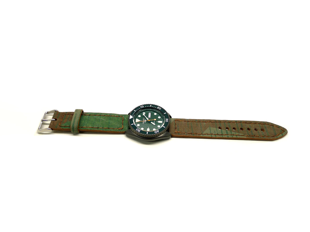 Madison watch strap in green and brown with dark edge stitching, shown fitted to a watch.
