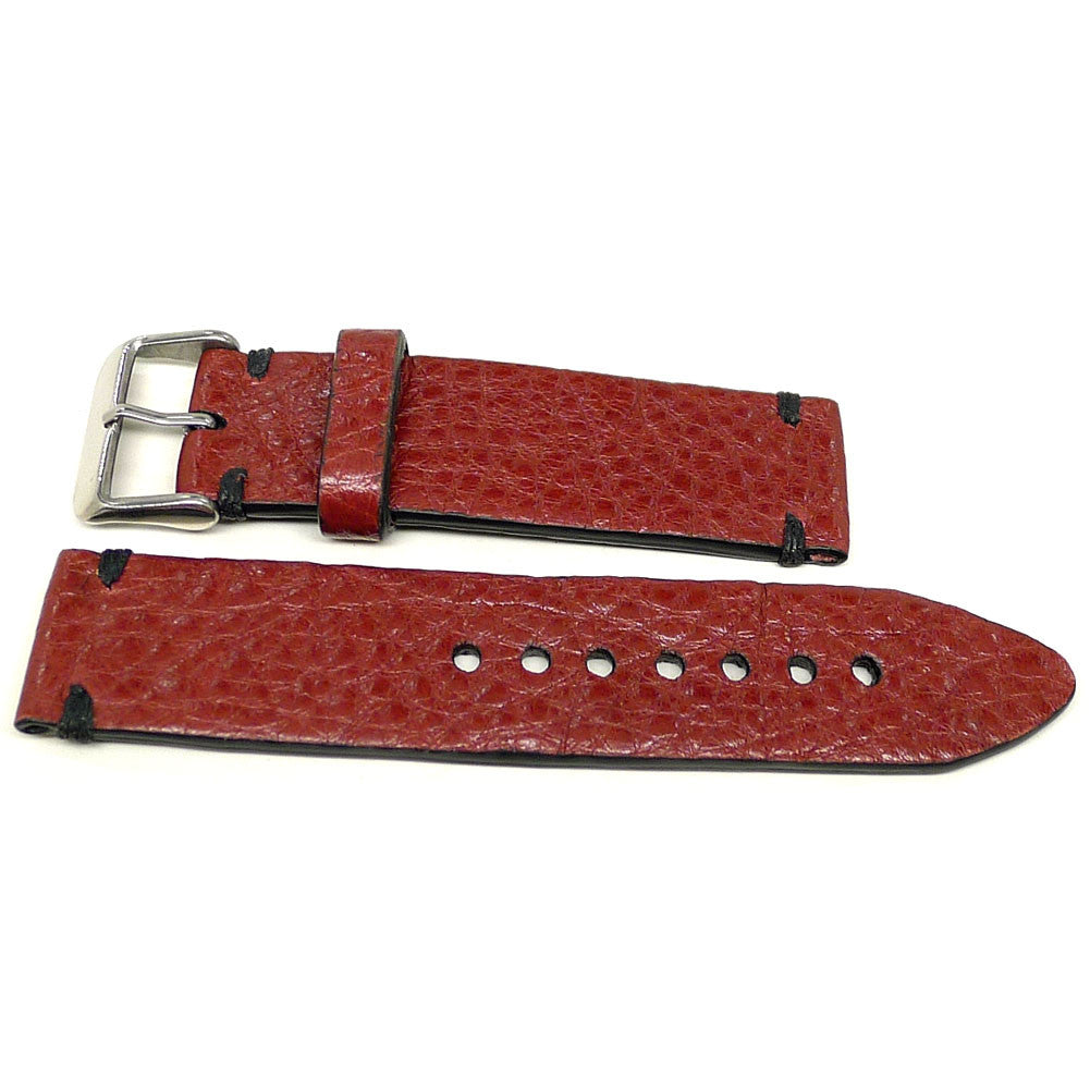 Nelthan watch strap in red with a textured surface and dark accent stitches, two pieces laid flat.