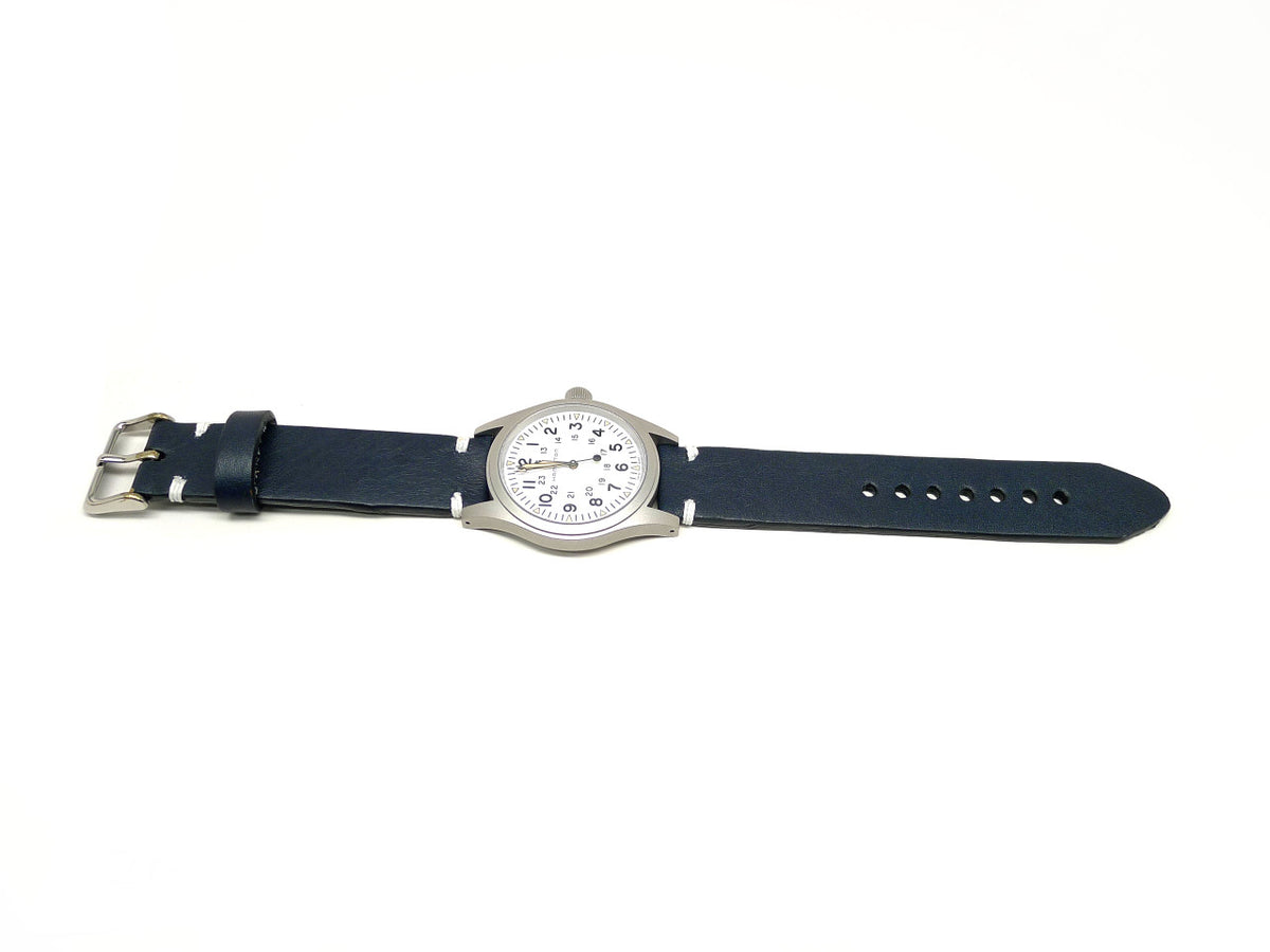 Perisice watch strap in dark blue with white accent stitches, shown fitted to a watch.