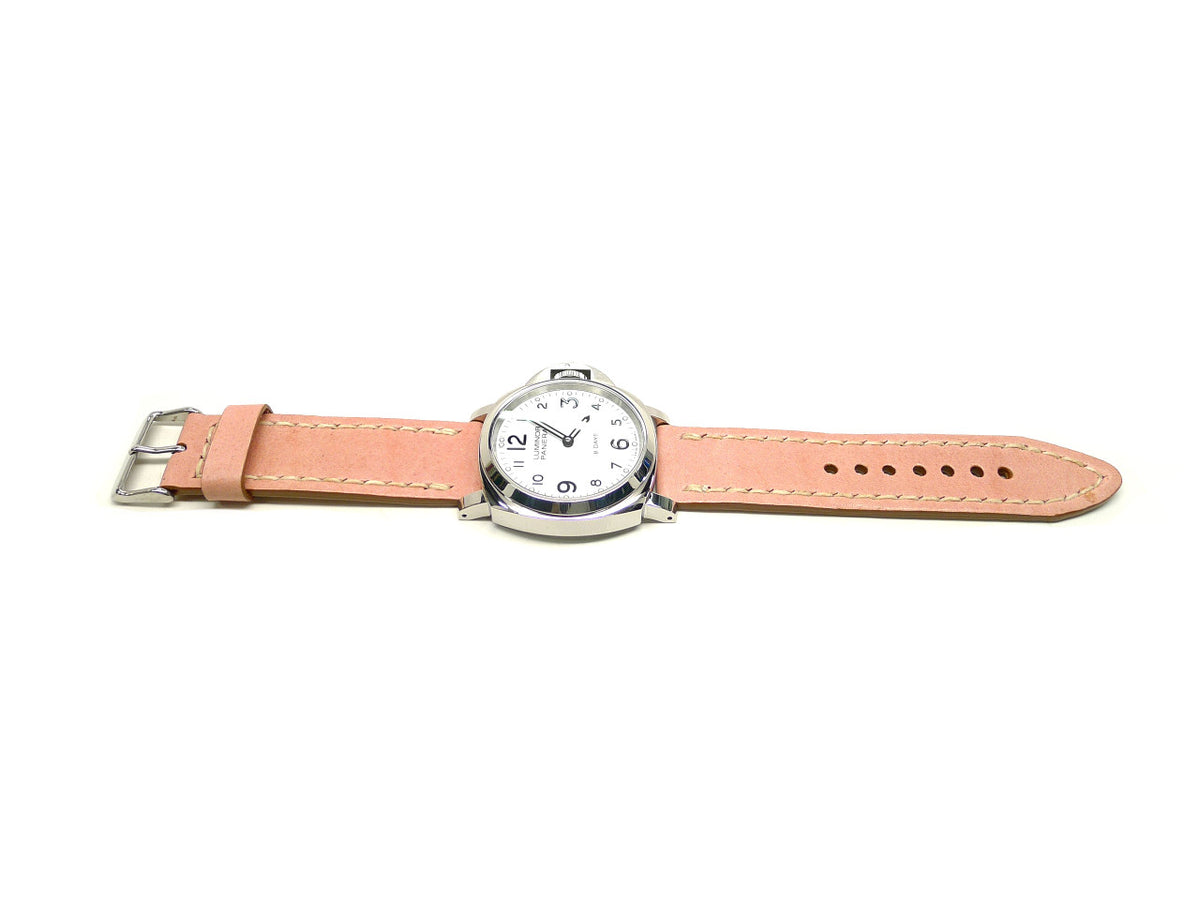 Swansea watch strap in pink with cream edge stitching, shown fitted to a watch.