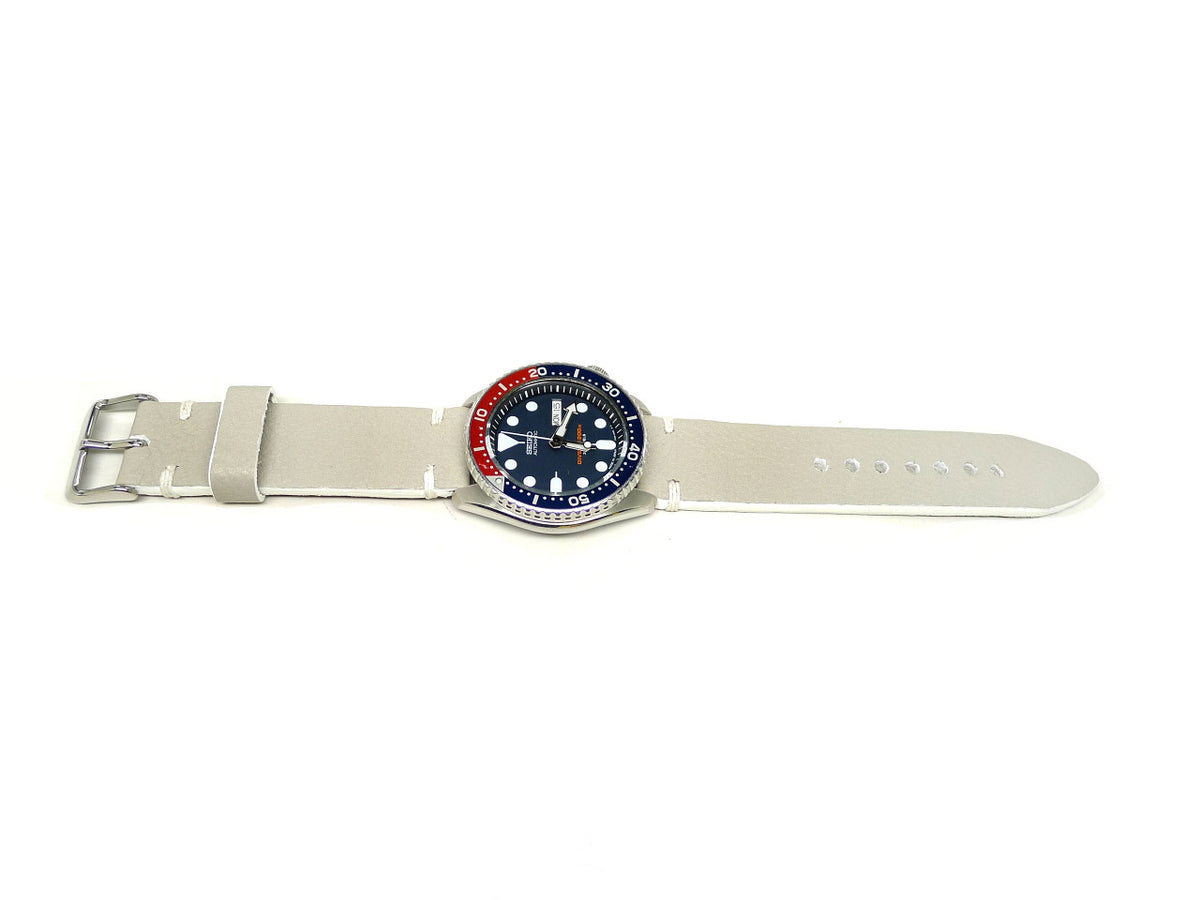 Tenzing watch strap in cream with white accent stitches, shown fitted to a watch.