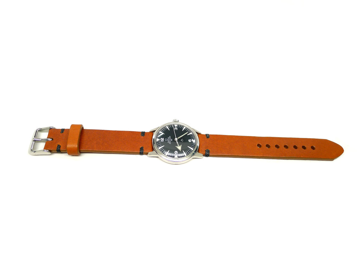 Tinxture watch strap in orange with dark accent stitches, shown fitted to a watch.