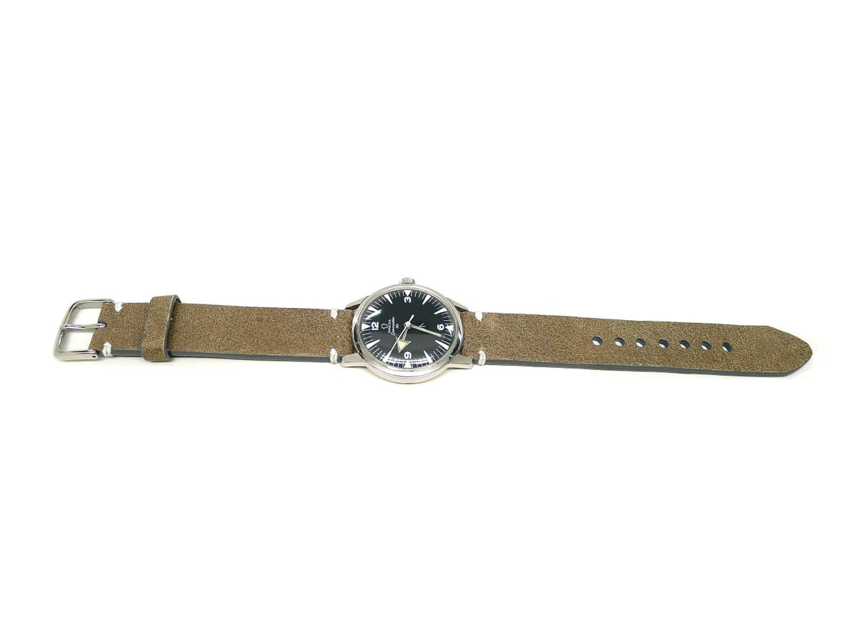 Torri watch strap in taupe with a textured surface and white accent stitches, shown fitted to a watch.