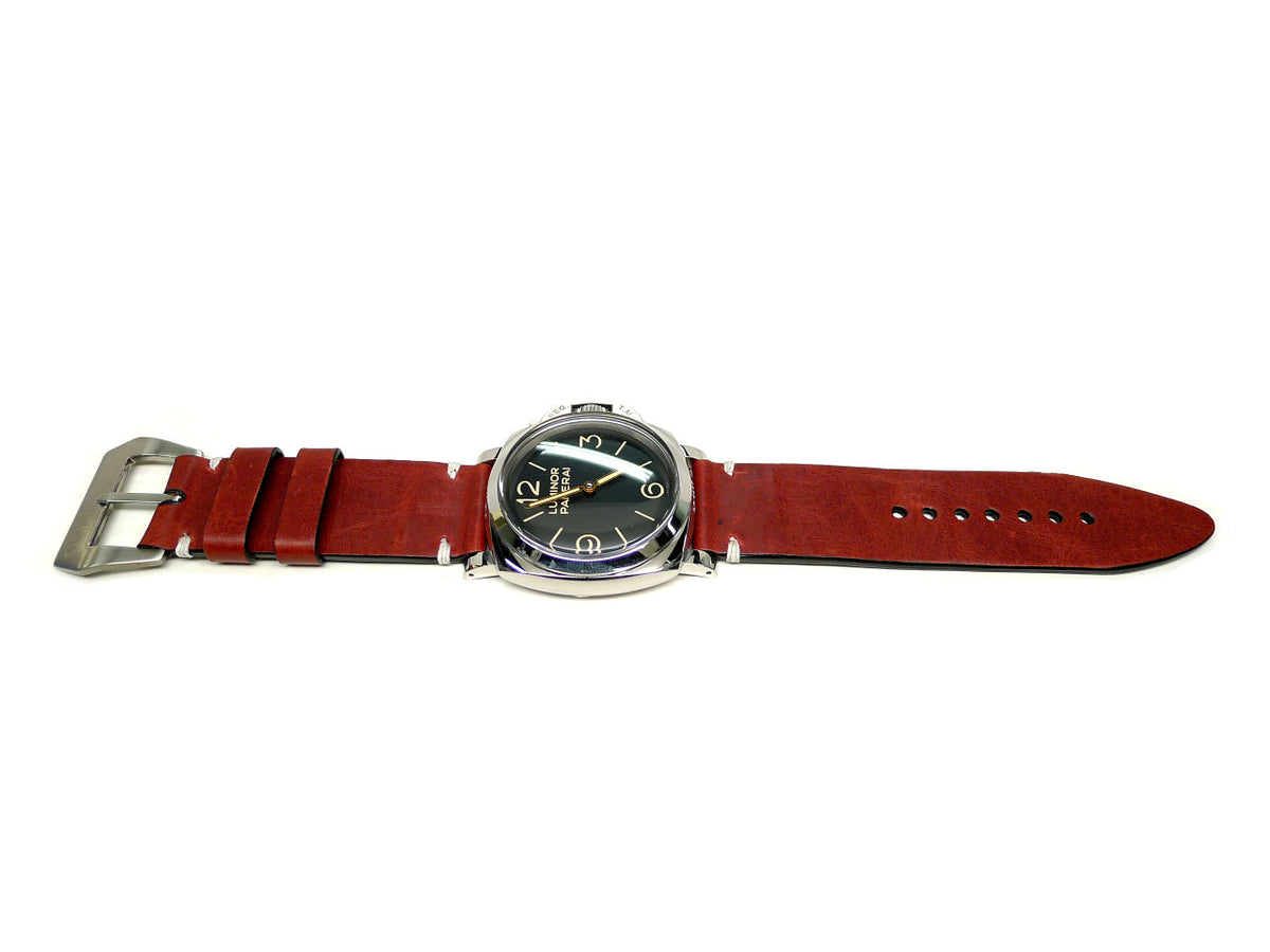 Vinum watch strap in dark red with cream accent stitches, shown fitted to a watch.